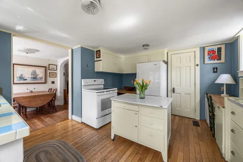 a kitchen with sink a stove and cabinets