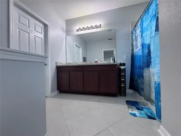 a spacious bathroom with a mirror and a bathtub