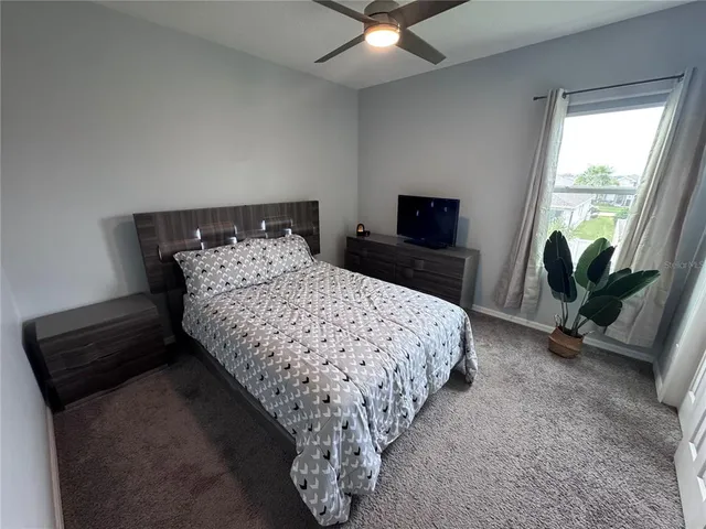 a bedroom with a bed and a chair