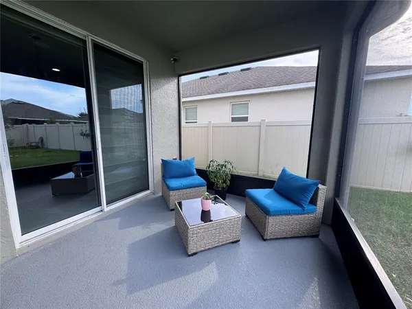 a outdoor living space with furniture and a rug