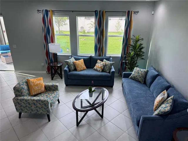 a living room with furniture and a large window