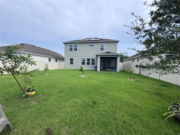 a view of a house with a backyard