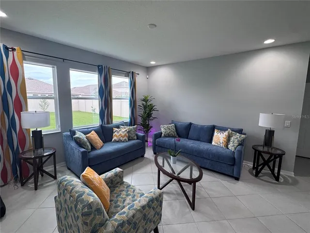 a living room with furniture and a large window