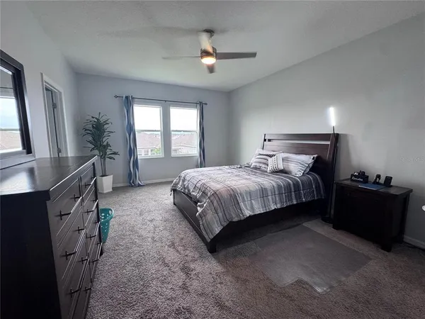 a bedroom with bed and window