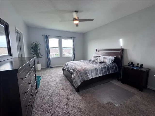 a bedroom with bed and window