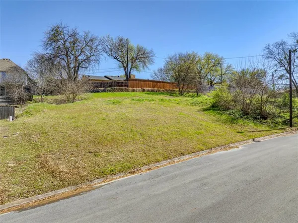 a view of swimming pool with lawn chairs and plants