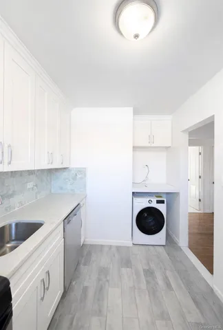 a kitchen with a sink a stove and cabinets