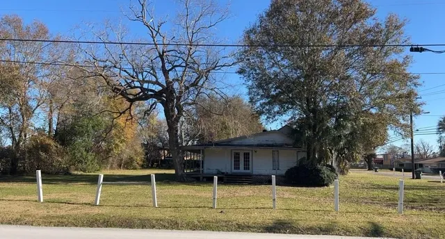 a front view of a house with a yard garage and outdoor seating