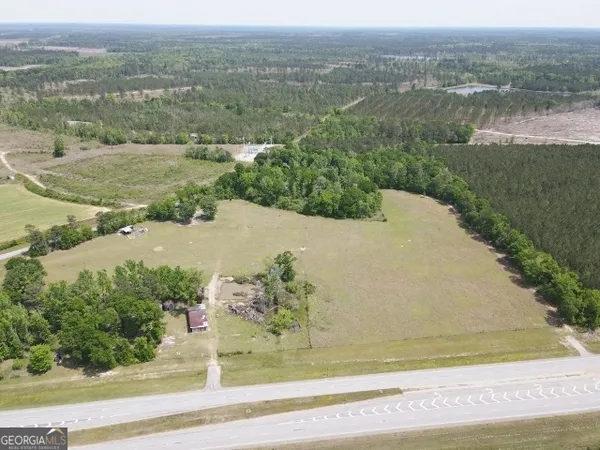 an aerial view of a house with a yard