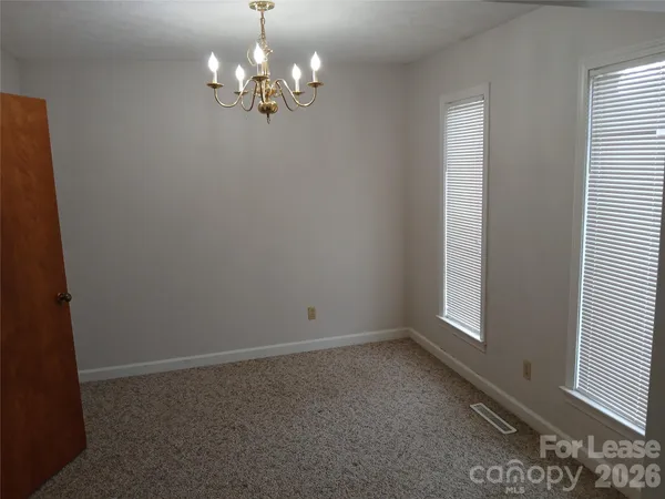 a view of a chandelier in big room and chandelier