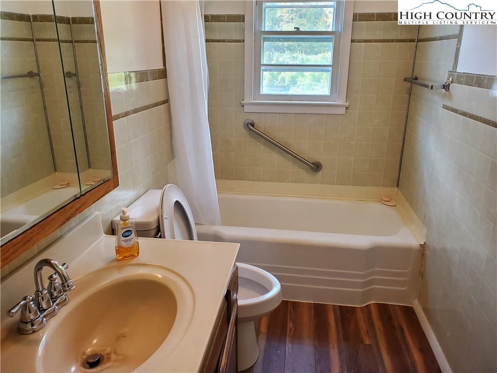 1411 Cabbage Creek Road Creston, NC 28615 - Photo 14 of 41 a bathroom with a sink and a bathtub