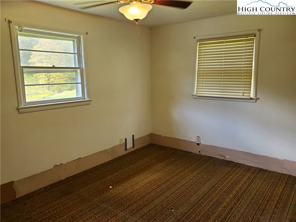 1411 Cabbage Creek Road Creston, NC 28615 - Photo 17 of 41 a view of a room with wooden floor and a window