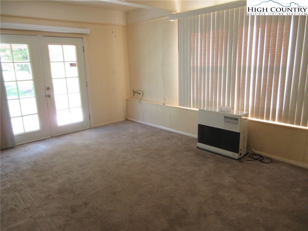 1411 Cabbage Creek Road Creston, NC 28615 - Photo 18 of 41 an empty room with windows