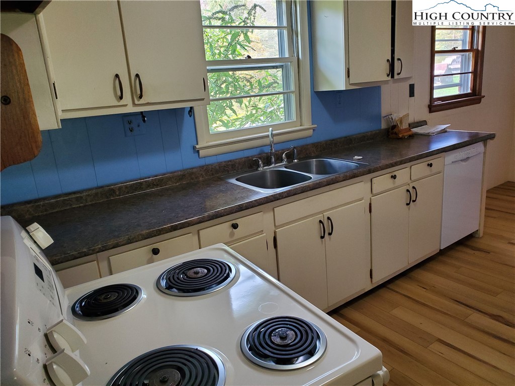 1411 Cabbage Creek Road Creston, NC 28615 - Photo 22 of 41 a kitchen with a sink and a stove next to a window