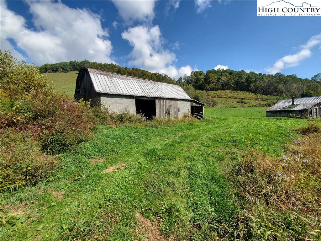1411 Cabbage Creek Road Creston, NC 28615 - Photo 26 of 41 a view of a big house with a big yard