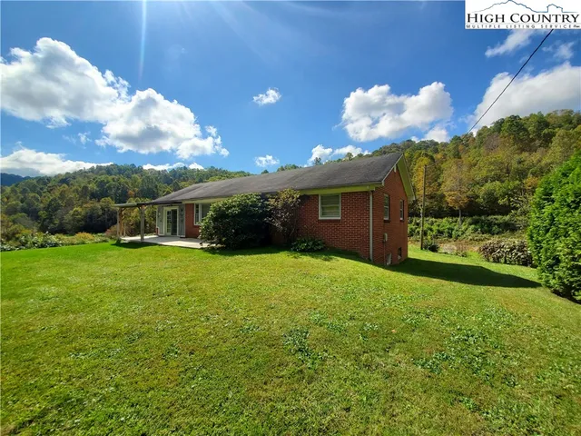 a kitchen with granite countertop a sink cabinets stainless steel appliances and a window