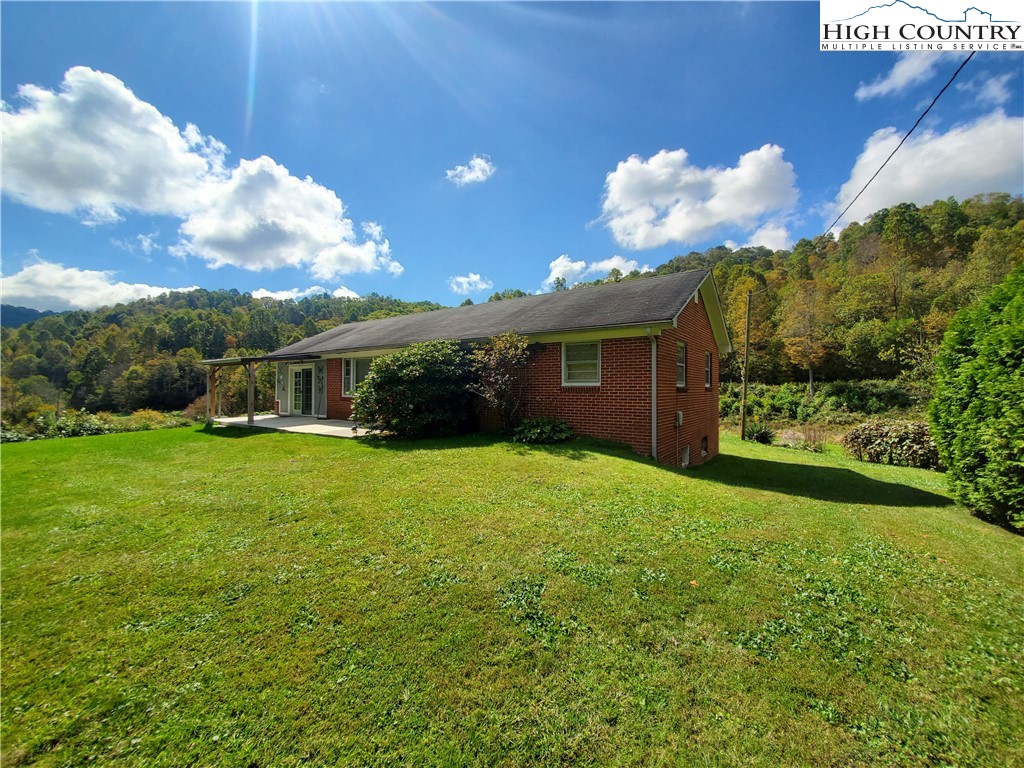 1411 Cabbage Creek Road Creston, NC 28615 - Photo 9 of 41 a view of a house with backyard and garden