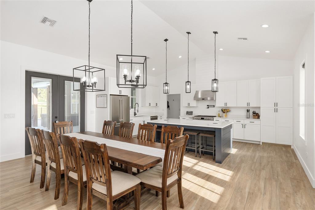 15224 Northwest 56th Court Road Reddick, FL 32686 - Photo 20 of 50 a view of a dining room and livingroom view with furniture wooden floor a chandelier