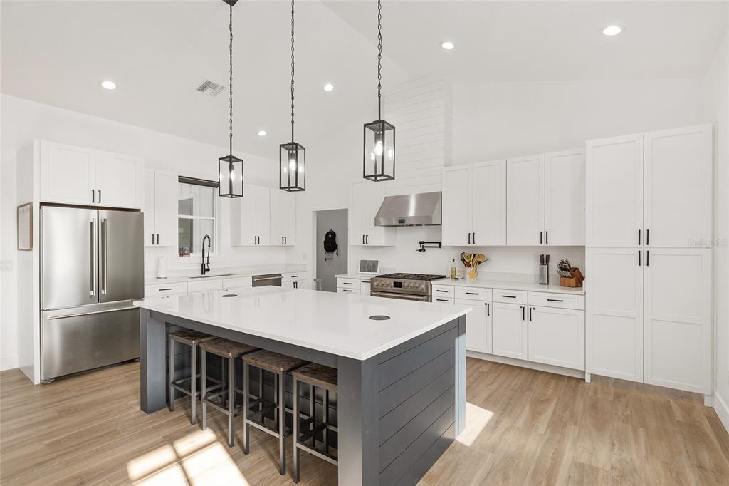 15224 Northwest 56th Court Road Reddick, FL 32686 - Photo 21 of 50 a kitchen with white cabinets and stainless steel appliances