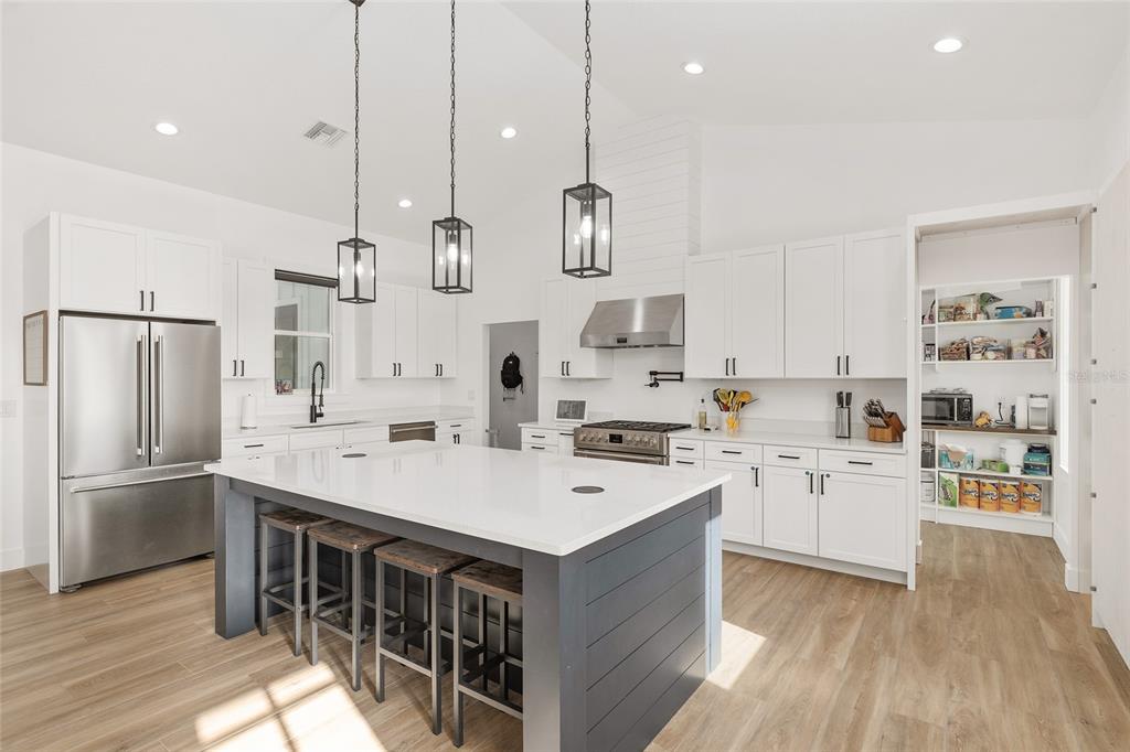 15224 Northwest 56th Court Road Reddick, FL 32686 - Photo 22 of 50 a kitchen with white cabinets and stainless steel appliances