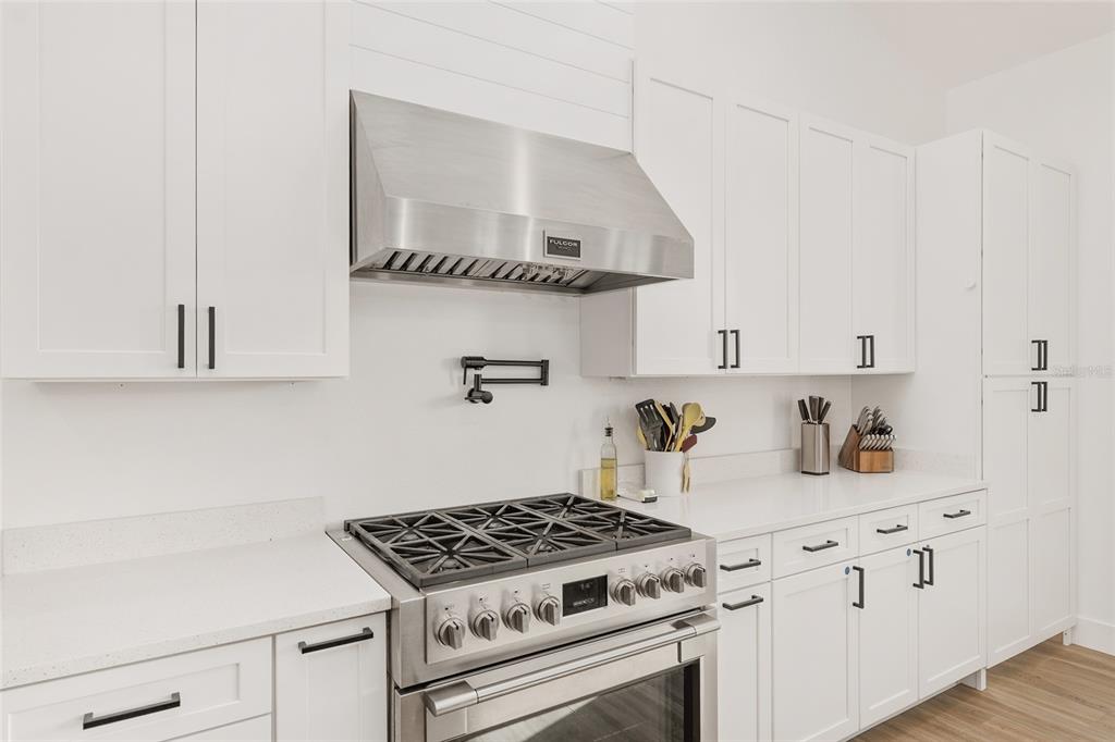 15224 Northwest 56th Court Road Reddick, FL 32686 - Photo 26 of 50 a kitchen with white cabinets and appliances