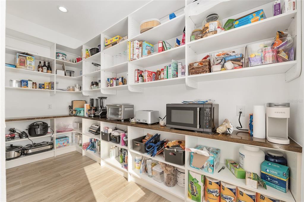 15224 Northwest 56th Court Road Reddick, FL 32686 - Photo 28 of 50 a kitchen with stainless steel appliances granite countertop a lot of cabinets and wooden floor