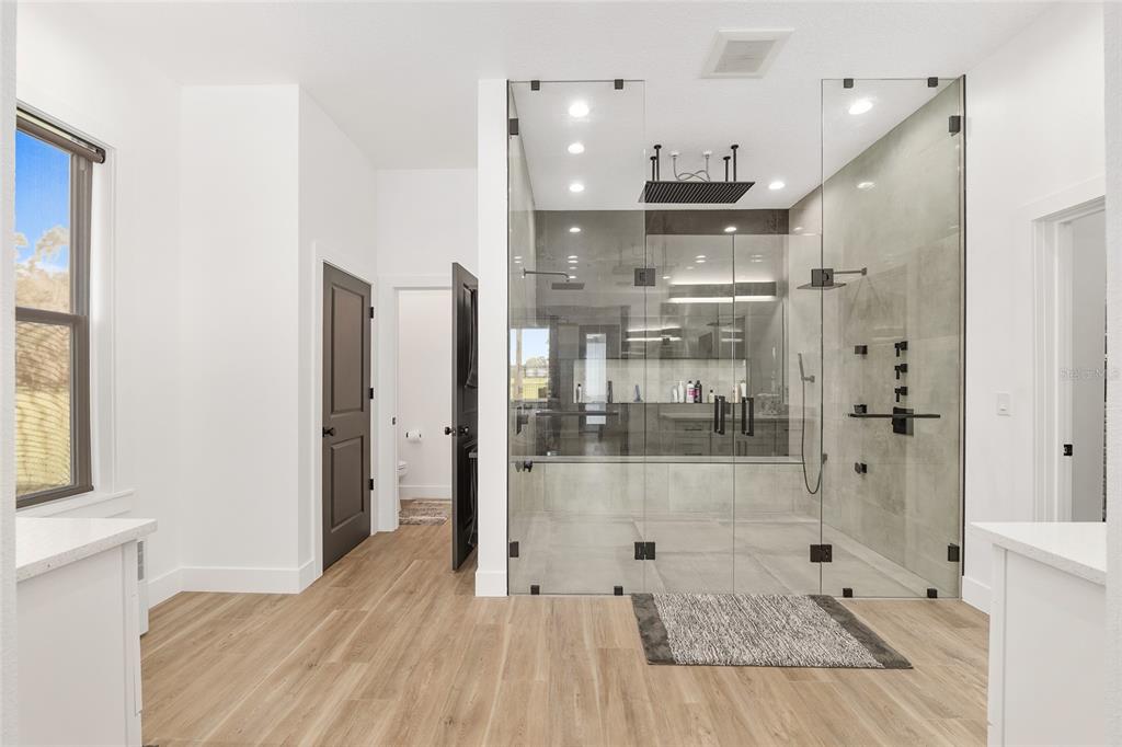 15224 Northwest 56th Court Road Reddick, FL 32686 - Photo 31 of 50 a bathroom with a glass shower door and a bathtub