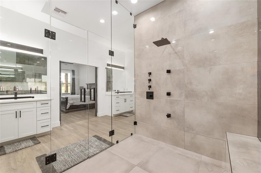 15224 Northwest 56th Court Road Reddick, FL 32686 - Photo 34 of 50 a spacious bathroom with a granite countertop sink mirror and shower