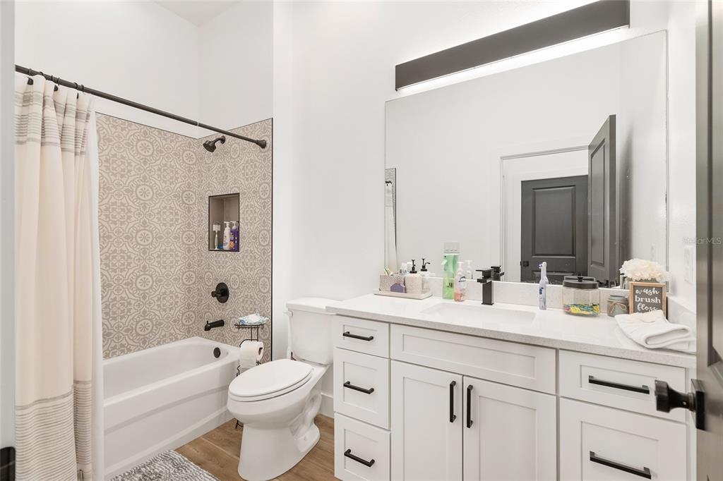 15224 Northwest 56th Court Road Reddick, FL 32686 - Photo 40 of 50 a bathroom with a toilet a sink a tub and mirror