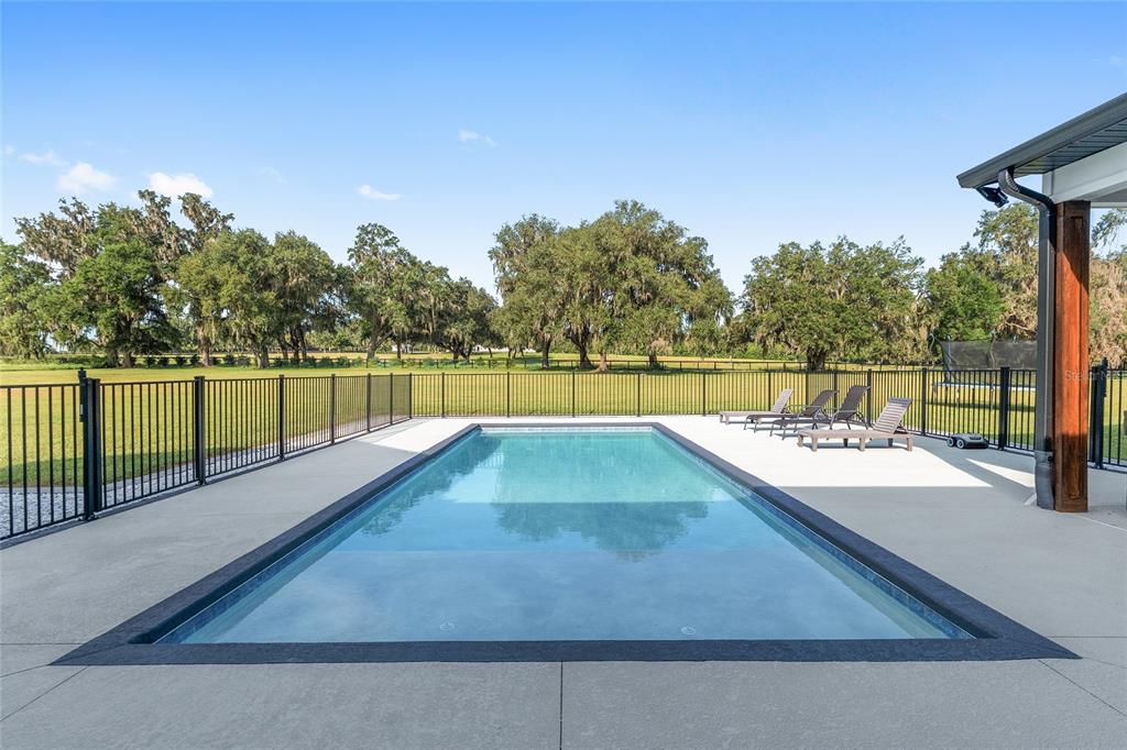 15224 Northwest 56th Court Road Reddick, FL 32686 - Photo 47 of 50 a view of a tennis court with trees in the background