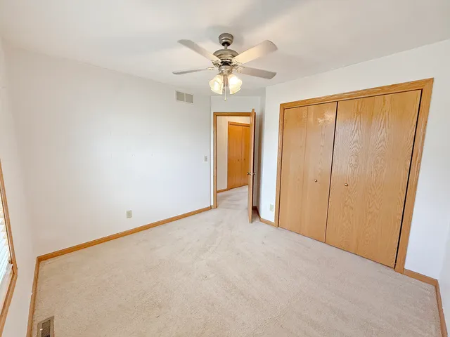 a view of an empty room with a ceiling fan