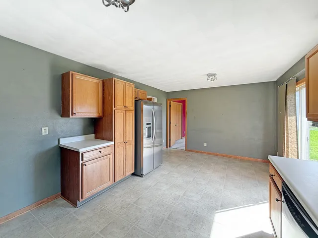 a kitchen with stainless steel appliances granite countertop a stove and a refrigerator