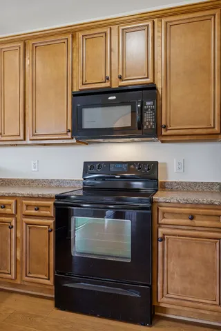 a stove top oven sitting inside of a kitchen