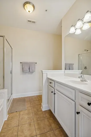 a bathroom with a granite countertop sink