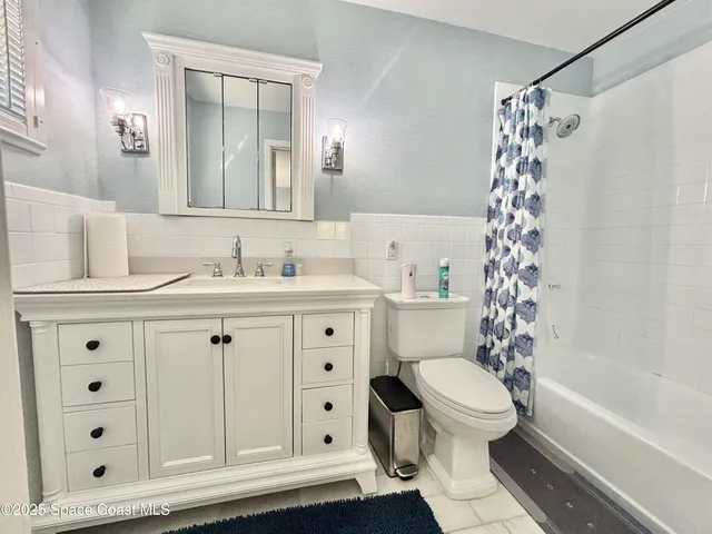 a view of a hallway with wooden floor and windows