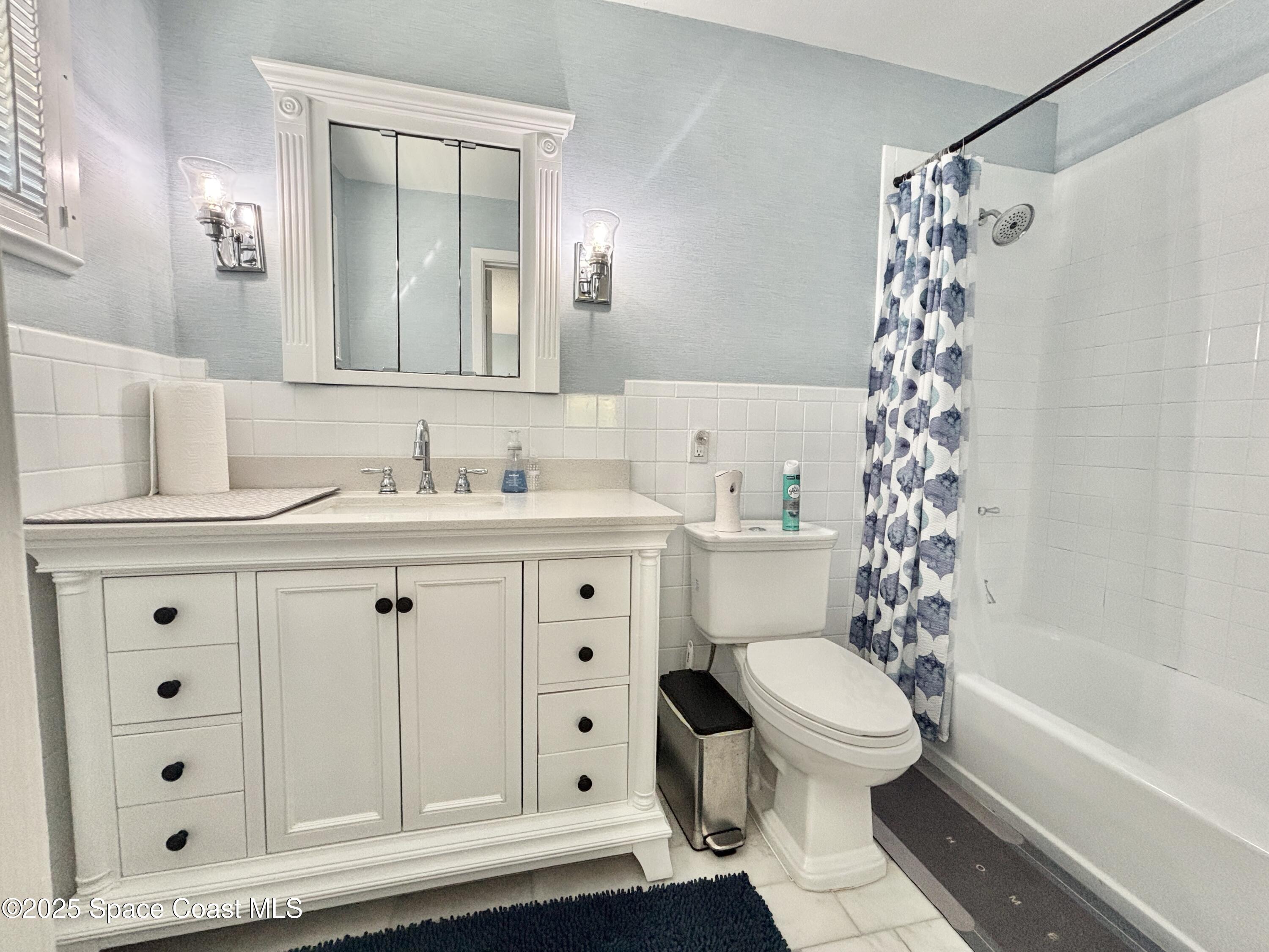 3955 Fooshe Avenue Sebastian, FL 32976 - Photo 18 of 45 a bathroom with a sink a toilet a vanity and a mirror