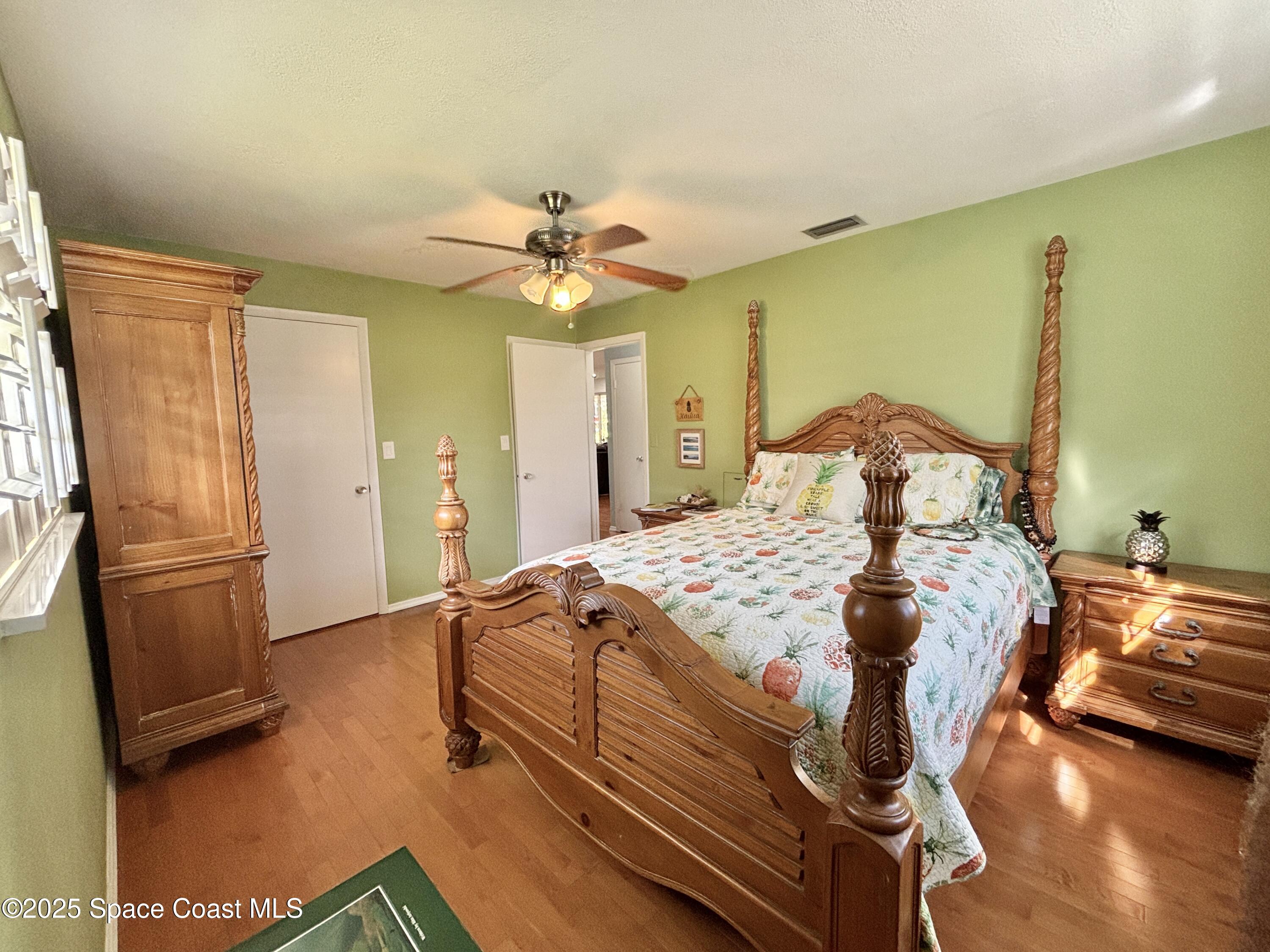 3955 Fooshe Avenue Sebastian, FL 32976 - Photo 20 of 45 a bedroom with a bed and wooden floor