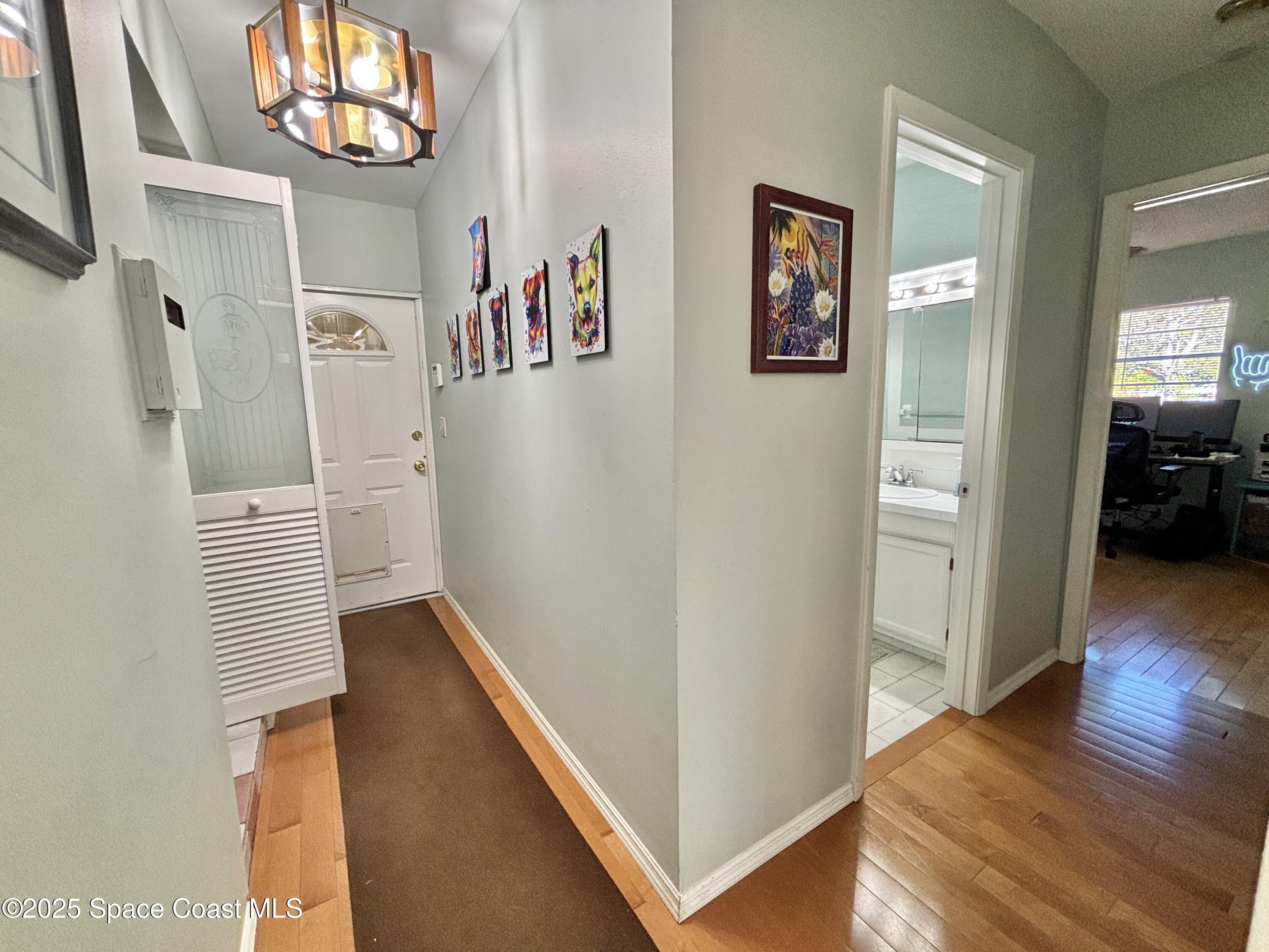 3955 Fooshe Avenue Sebastian, FL 32976 - Photo 21 of 45 a view of a hallway with wooden floor and windows