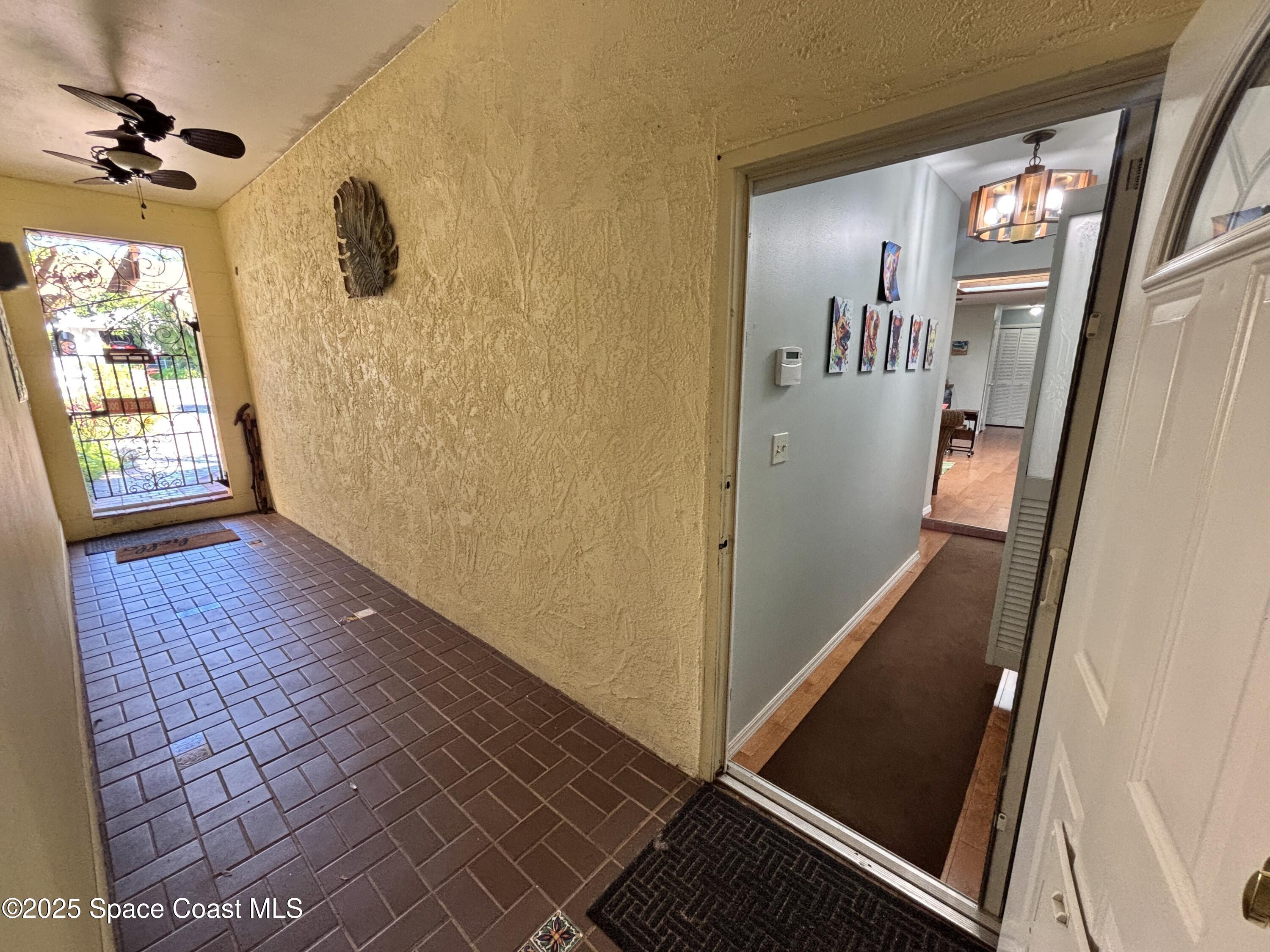 3955 Fooshe Avenue Sebastian, FL 32976 - Photo 25 of 45 a view of a hallway with wooden floor and windows
