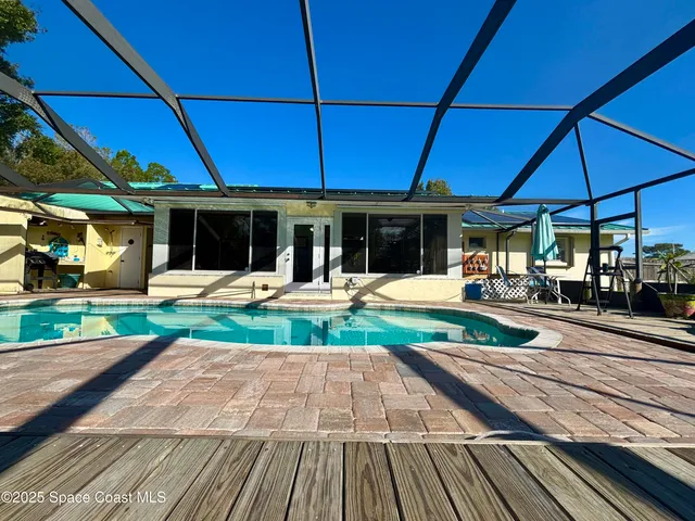 front view of a house with swimming pool and porch