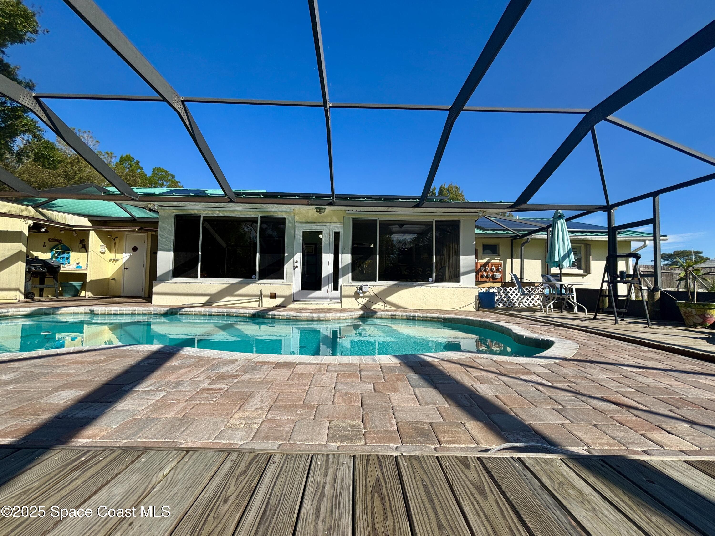 3955 Fooshe Avenue Sebastian, FL 32976 - Photo 28 of 45 a view of a table and chairs under an umbrella