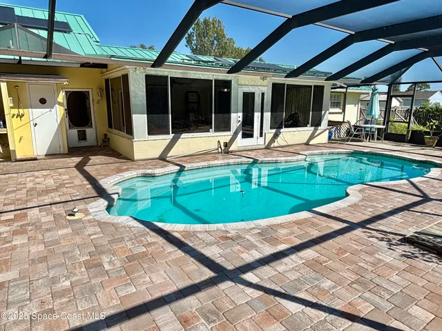a view of a roof deck with table and chairs a barbeque
