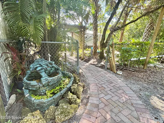 a view of a patio with table and chairs and potted plants