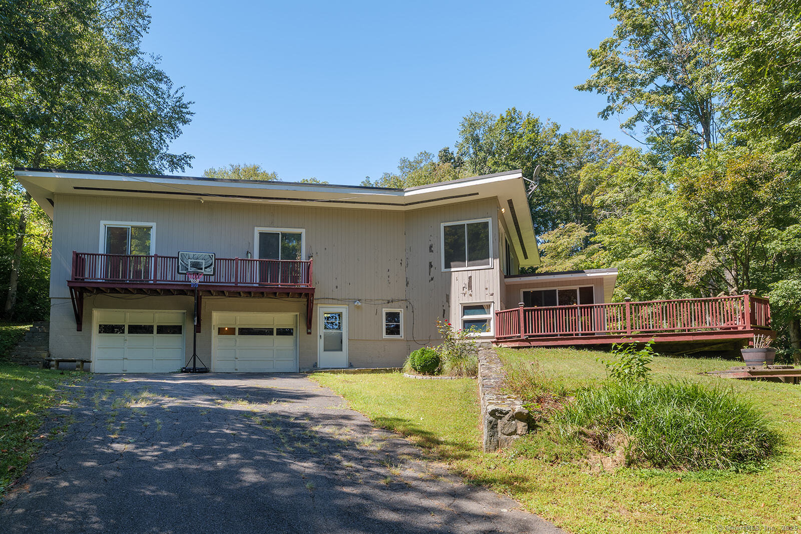 26 Wilridge Road Ridgefield, CT 06877 - Photo 7 of 40 a view of a house with a yard and a garage