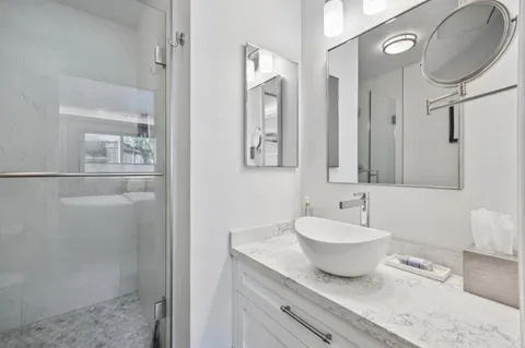 a bathroom with a shower a toilet and sink