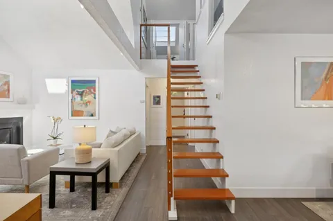 a view of entryway and hall with wooden floor