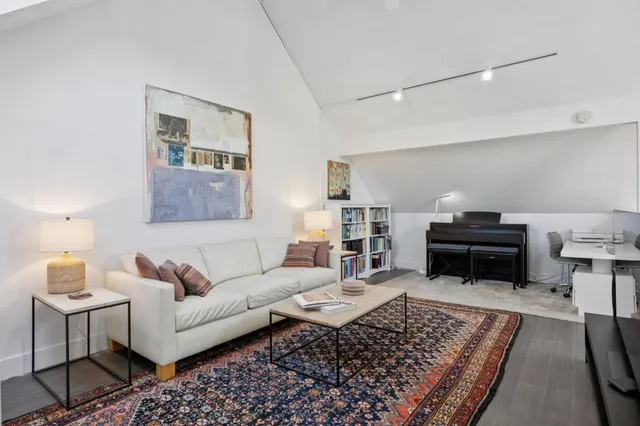 a living room with furniture and a piano