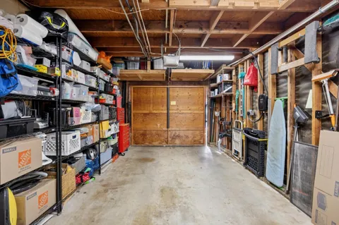 a patio with a table and chairs under an umbrella