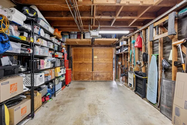 a patio with a table and chairs under an umbrella