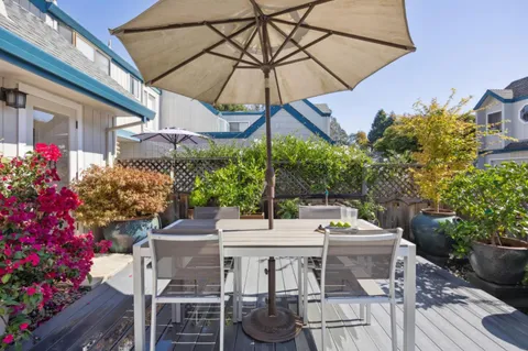 a view of a chair and table in the backyard
